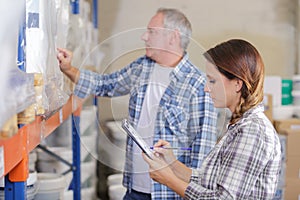 Workers checking stock on racking