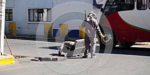 Workers cleaning city drain