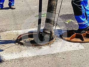Workers cleaning the sewage at a residentual house