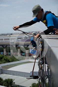 Workers cleaning windows service on high rise building