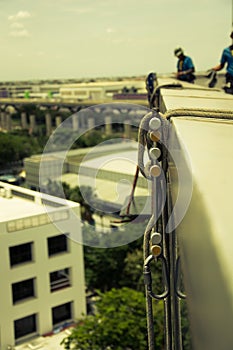 Workers cleaning windows service on high rise building