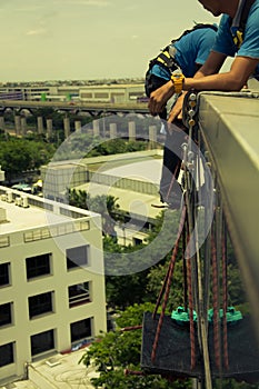 Workers cleaning windows service on high rise building