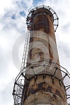 Workers climbing on the big chimney