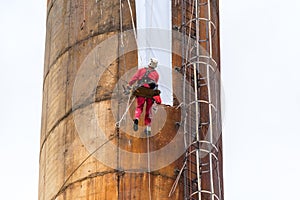 Workers climbing on the big chimney
