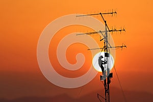 Workers are climbing to repair the telecommunication tower,Red s