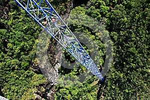 Workers climing supporting pole, Sky Bridge