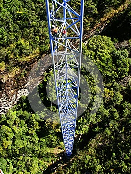 Workers climing supporting pole, Sky Bridge