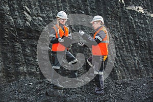 Workers with coal at open pit