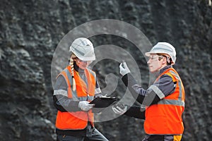 Workers with coal at open pit
