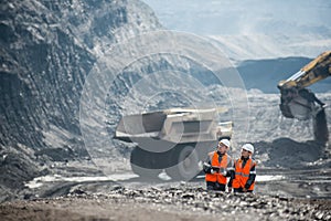Workers with coal at open pit
