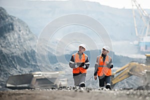 Workers with coal at open pit