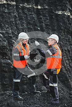 Workers with coal at open pit