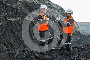 Workers with coal at open pit