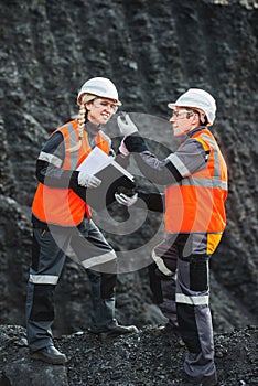Workers with coal at open pit