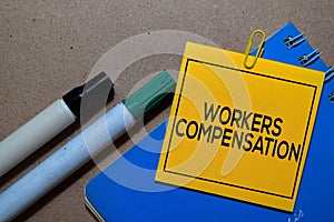 Workers Compensation write on sticky notes isolated on Office Desk photo