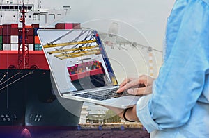 Workers with computer note book in port during cargo ship loading