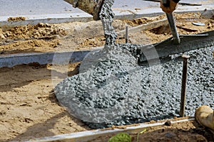 Workers concrete mixer with pouring cement during to residential on sidewalk