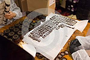 Workers at confectionery shop packing candies