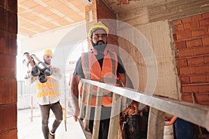 Workers In Construction Site Using Tools And Heavy Equipment photo