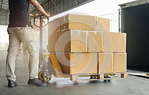 Workers Courier Unloading Packaging Boxes on Pallet into Cargo Container Trucks. Shipping Warehouse. Delivery Shipment Boxes.