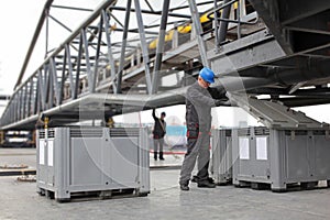 Workers in coveralls and hardhats working at industrial site