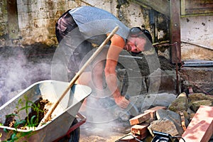 Workers with cut-off grinder in use
