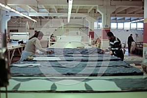 Workers cutting fabric