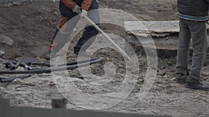 Workers digging shovels at a construction site, industry. Manual labor, work