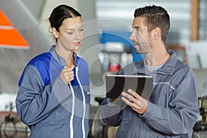 workers discussing as team with tablet computer
