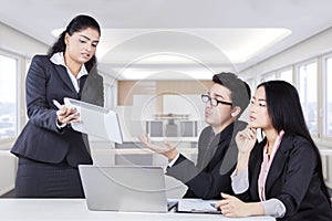 Workers discussing with digital tablet computer