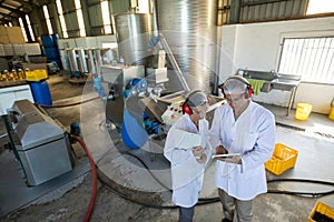 Workers discussing over digital tablet