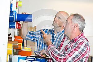 Workers discussing paper rolls printers