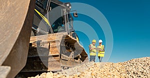 Workers discussing their job in quarry or gravel pit