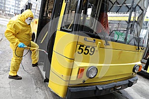 Workers disinfecting bus