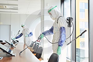 Workers Disinfecting Conference Room