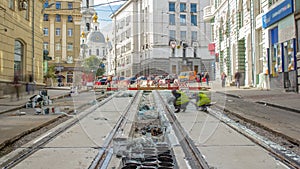 Workers do cleaning of the railway tram line after construction works.