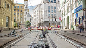 Workers do cleaning of the railway tram line after construction works.