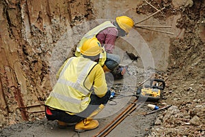 Workers drilling concrete using mobile drilling machine