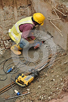 Workers drilling concrete using mobile drilling machine
