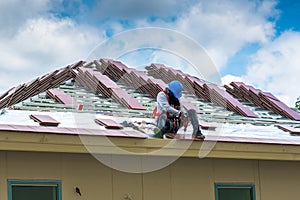 Workers are drilling roof tiles with a drill.