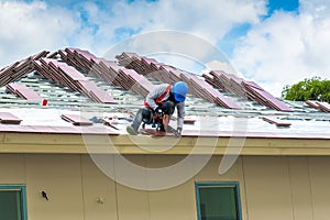 Workers are drilling roof tiles with a drill.