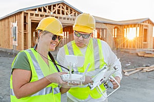 Workers with Drone Quadcopter Inspecting Photographs on Controller