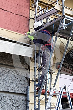 workers engaged in assembling a scaffolding photo