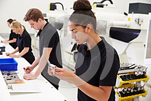 Workers In Engineering Factory Checking Component Quality