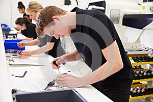 Workers In Engineering Factory Checking Component Quality