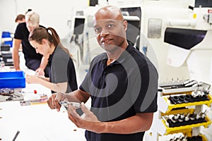 Workers In Engineering Factory Checking Component Quality photo