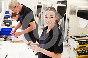 Workers In Engineering Factory Checking Component Quality