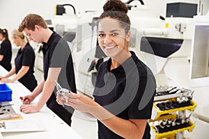 Workers In Engineering Factory Checking Component Quality