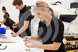 Workers In Engineering Factory Checking Component Quality
