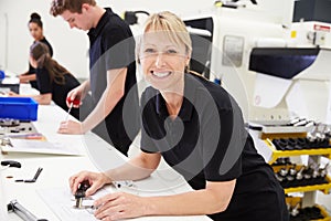 Workers In Engineering Factory Checking Component Quality